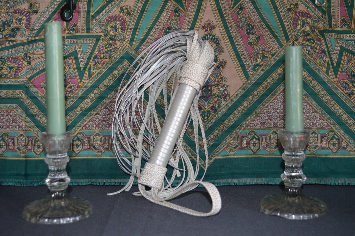 A completely handmade whip made of white leather.